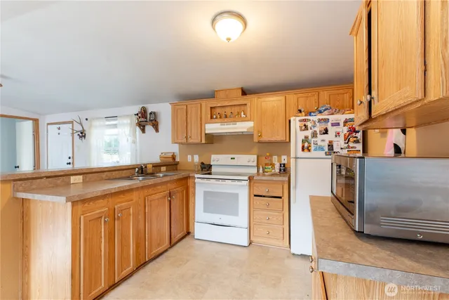 a kitchen with stainless steel appliances granite countertop a stove and a refrigerator
