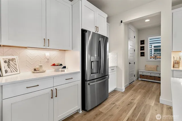 a kitchen with stainless steel appliances a refrigerator sink and cabinets