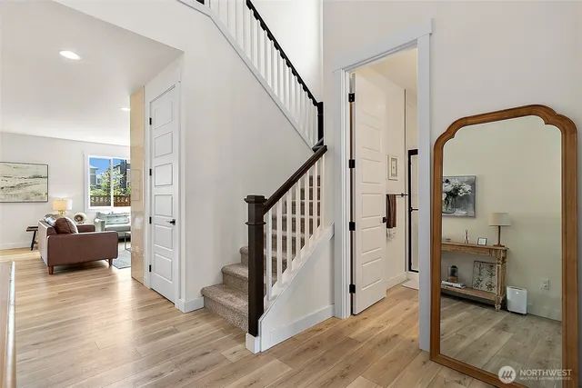 a view of an entryway with wooden floor and windows