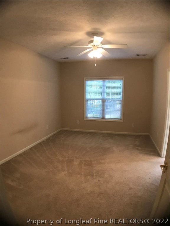 522 Lionshead Road, Unit 3 Fayetteville, NC 28311 - Photo 15 of 20 en empty room with windows and chandelier fan