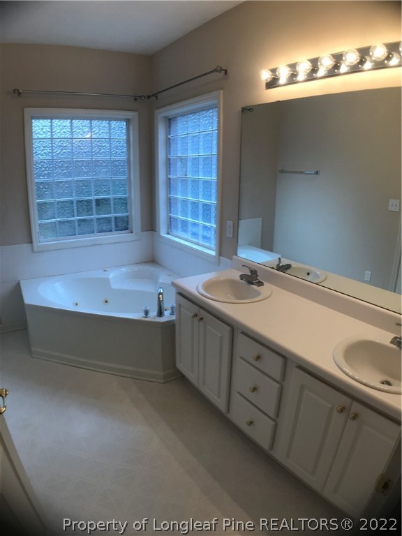 522 Lionshead Road, Unit 3 Fayetteville, NC 28311 - Photo 18 of 20 a bathroom with a tub sink and mirror