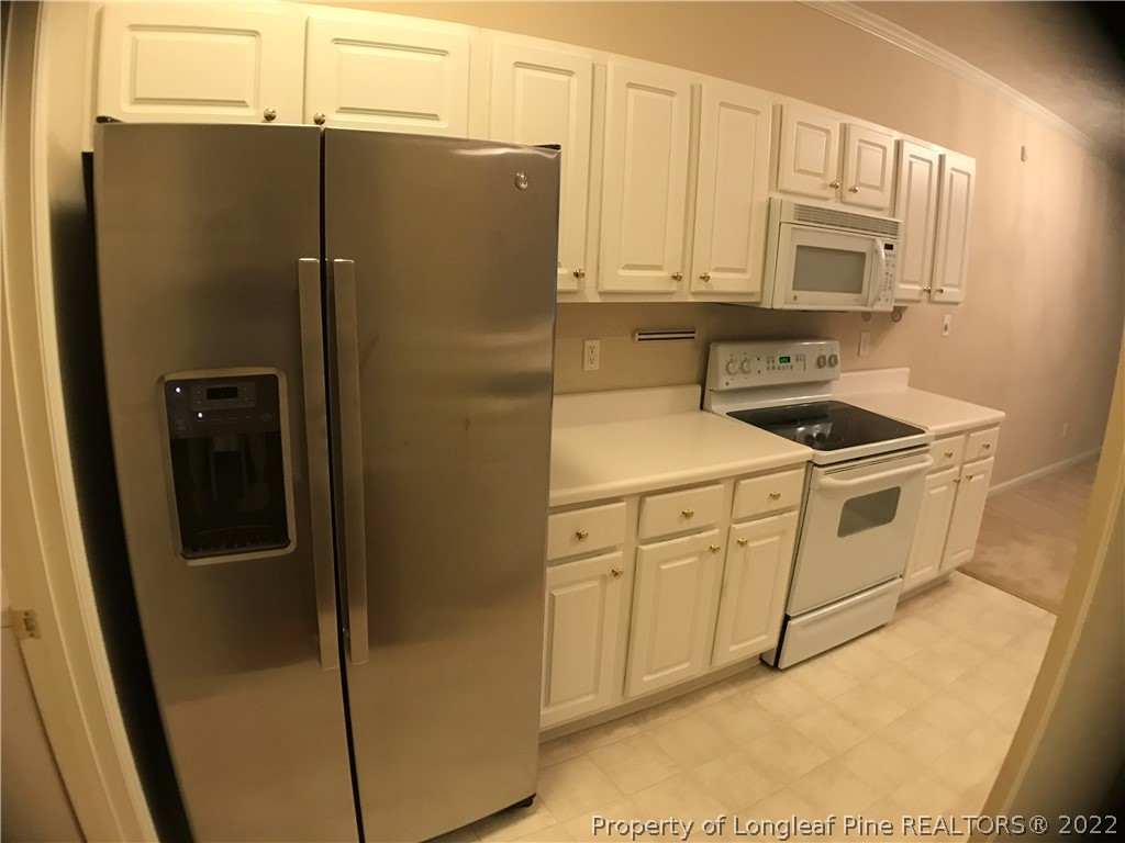 522 Lionshead Road, Unit 3 Fayetteville, NC 28311 - Photo 8 of 20 a kitchen with stainless steel appliances white cabinets and a refrigerator