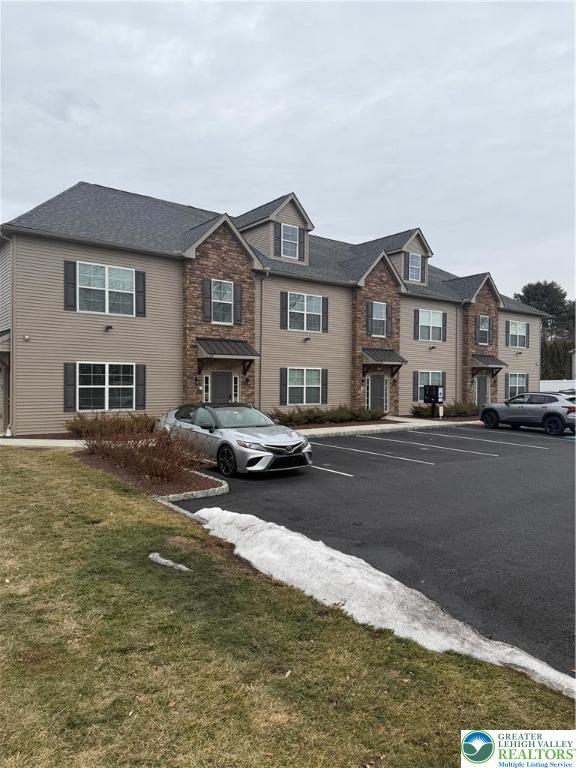 1036 Blake Street, Unit 101 Bethlehem, PA 18017 - Photo 12 of 12 a front view of a house with a garden and lake view