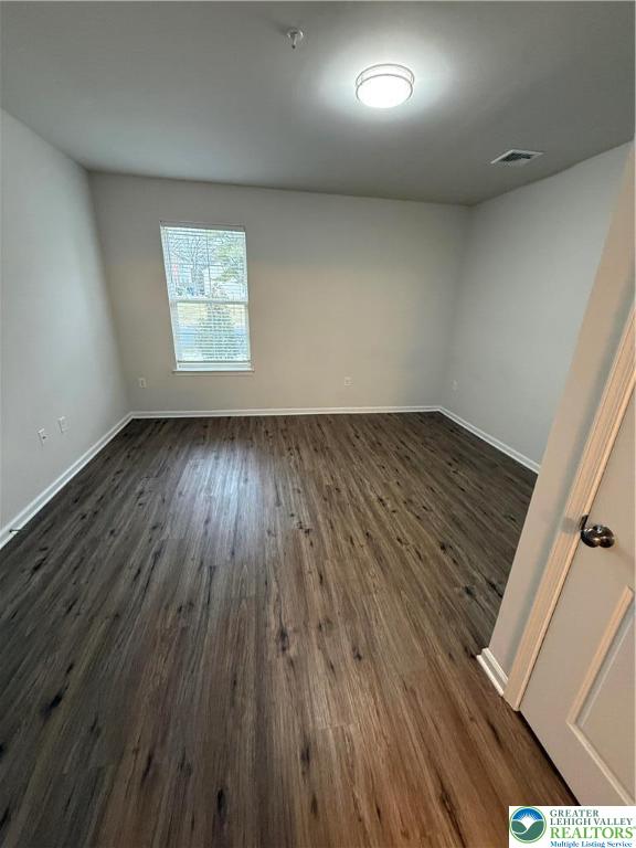 1036 Blake Street, Unit 101 Bethlehem, PA 18017 - Photo 8 of 12 an empty room with wooden floor and windows