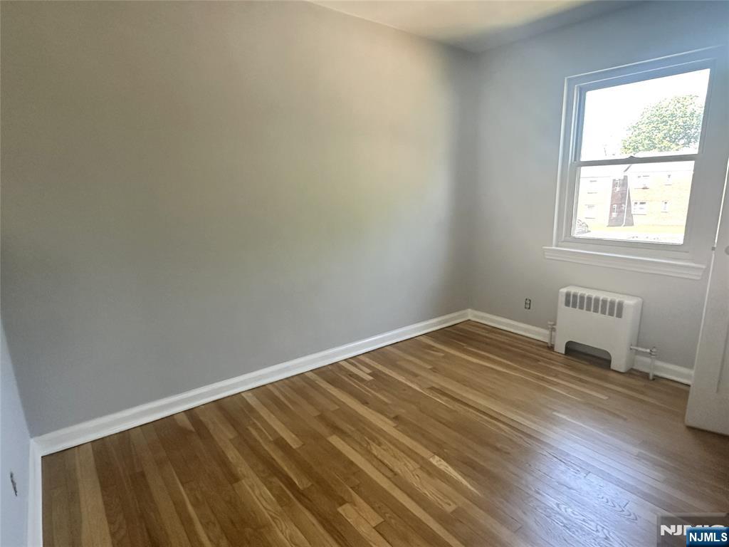 460 Heath Place, Unit 48 Hackensack, NJ 07601 - Photo 8 of 10 a view of a room with wooden floor and bedroom