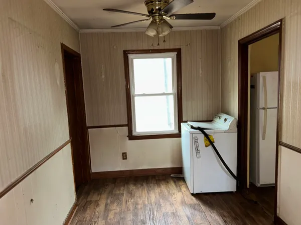 a view of a hallway with wooden floor and staircase