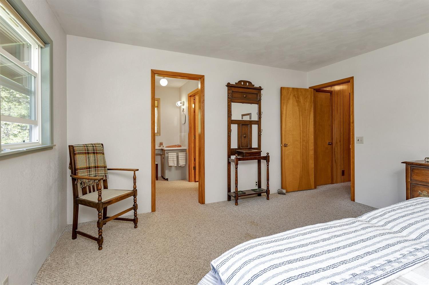 11851 Upper Applegate Road Jacksonville, OR 97530 - Photo 24 of 34 a bedroom with a bed and a chair