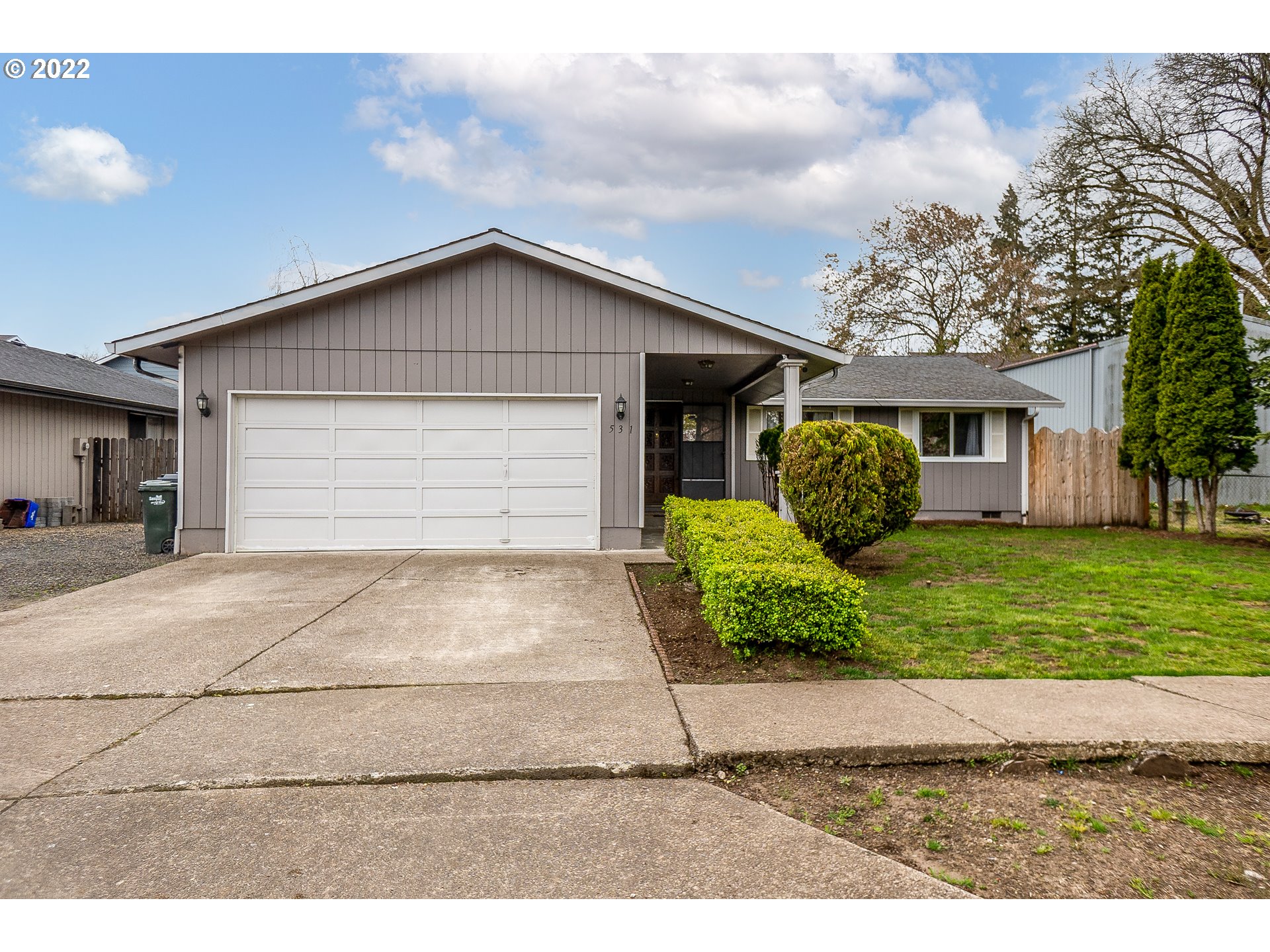 531 T Street Springfield, OR 97477 - Photo 1 of 17 a front view of a house with a yard and garage