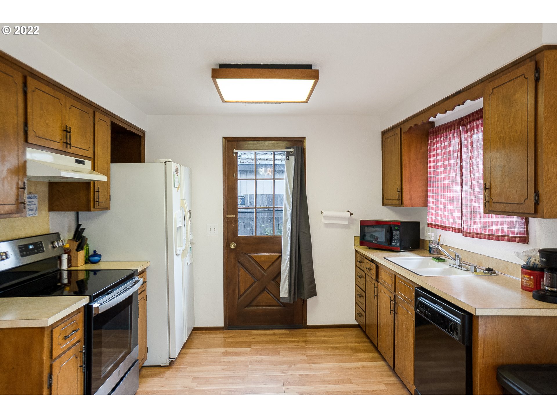 531 T Street Springfield, OR 97477 - Photo 7 of 17 a kitchen with stainless steel appliances granite countertop a sink stove and refrigerator