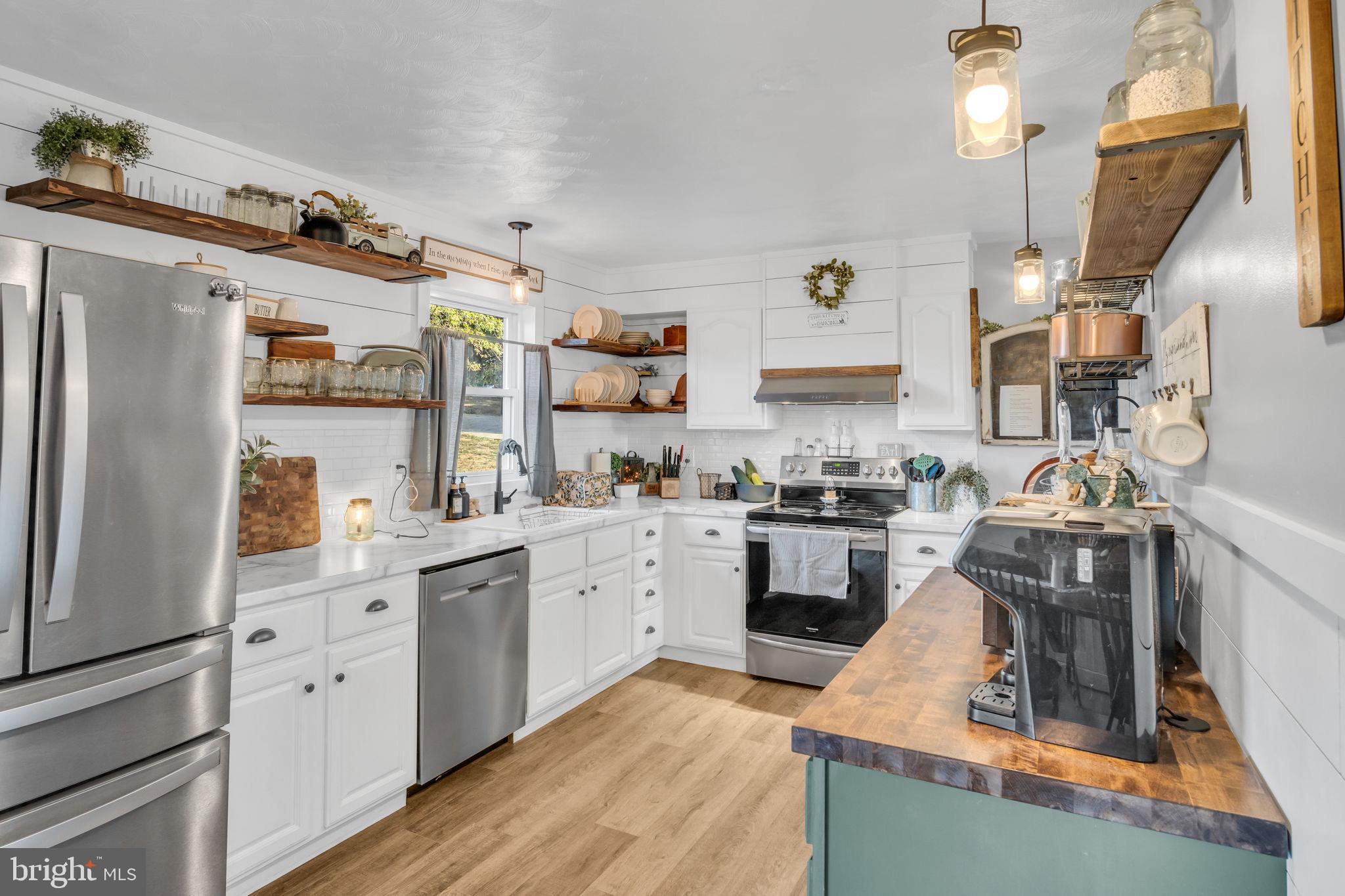 623 Bloserville Road Newville, PA 17241 - Photo 11 of 49 a kitchen with stainless steel appliances granite countertop a sink stove and refrigerator