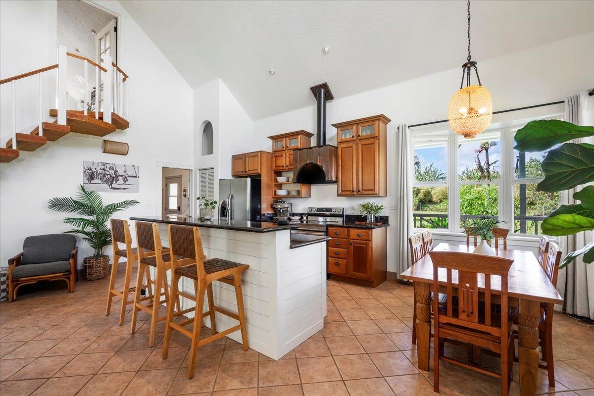 44 Kaupakalua Road Haiku, HI 96708 - Photo 15 of 48 a kitchen with stainless steel appliances granite countertop a table and chairs in it