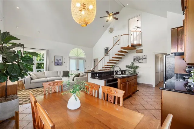 a living room with fireplace furniture and a potted plant