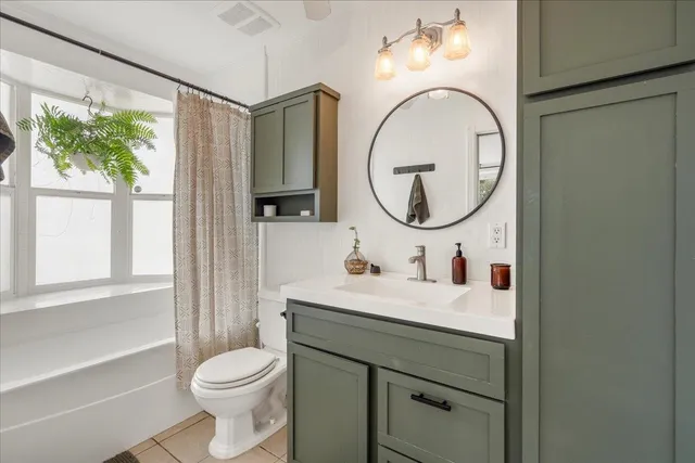 a bathroom with a toilet a sink and a mirror