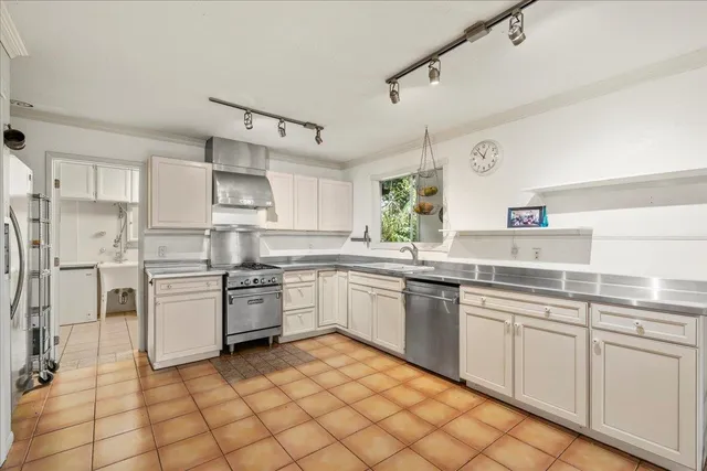 an empty room with wooden floor chandelier fan and windows