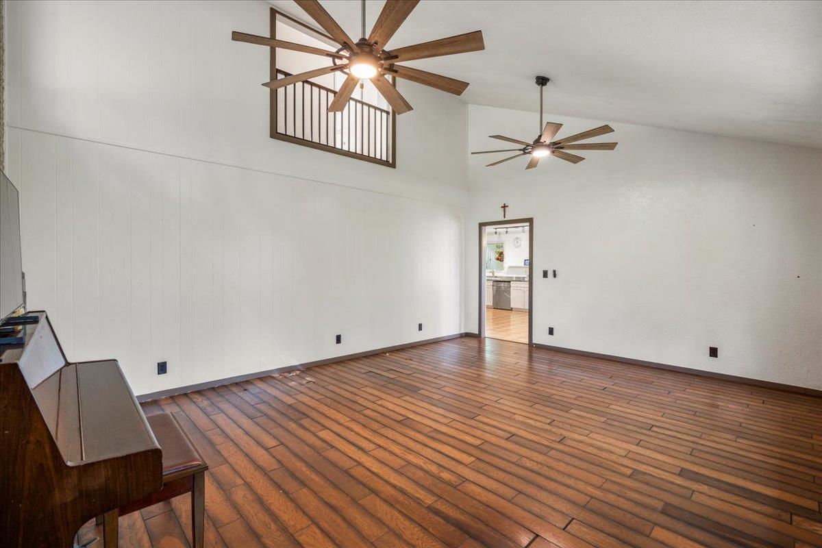 44 Kaupakalua Road Haiku, HI 96708 - Photo 40 of 48 an empty room with wooden floor chandelier fan and windows