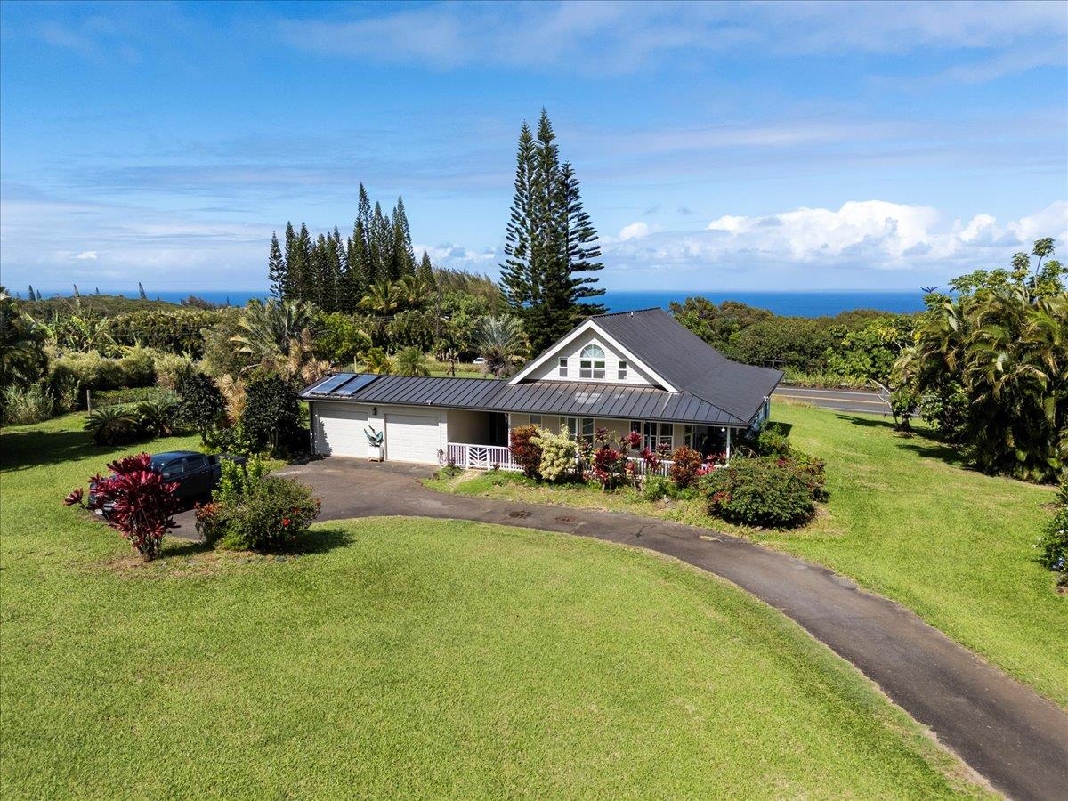 44 Kaupakalua Road Haiku, HI 96708 - Photo 7 of 48 a front view of a house with yard and green space