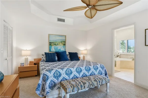 a bedroom with a bed and ceiling fan