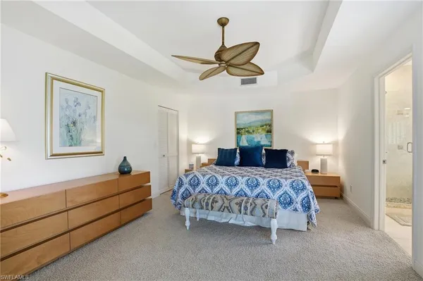 a bedroom with a bed lamp and window