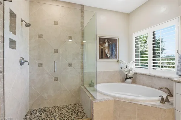 a bathroom with a bathtub and shower