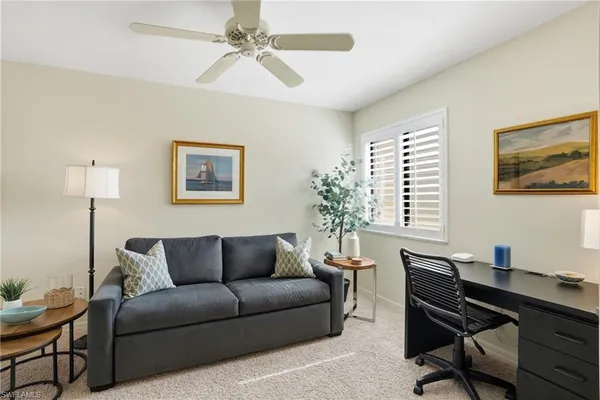 a living room with furniture and a potted plant