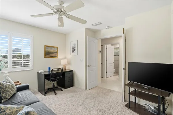 a livingroom with workspace and a window