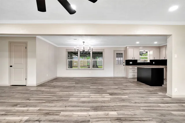a view of kitchen and hall with wooden floor