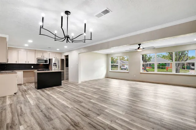 a view of a kitchen with a sink and a wooden floor