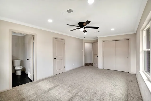 a view of an empty room with a bathroom