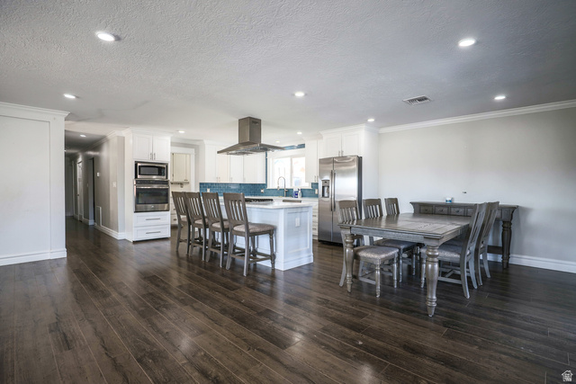 422 West Buckeye Reef Road Leeds, UT 84746 - Photo 21 of 47 Dining space featuring dark wood-style floors, recessed lighting, a textured ceiling, and crown molding