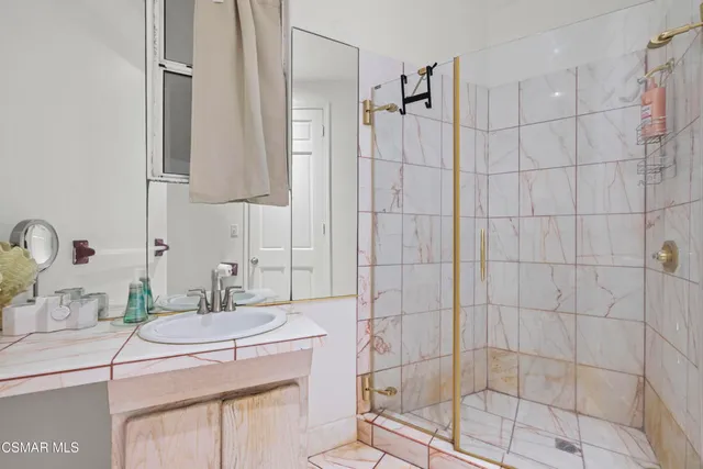 a living room with furniture a rug and a floor to ceiling window