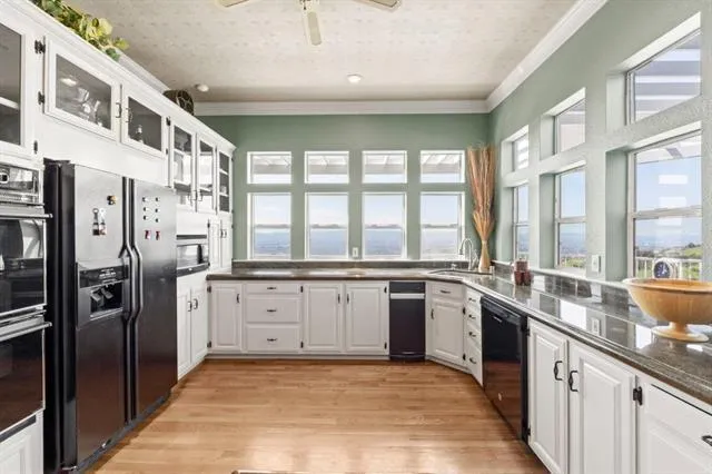 a large room with lots of counter space and windows