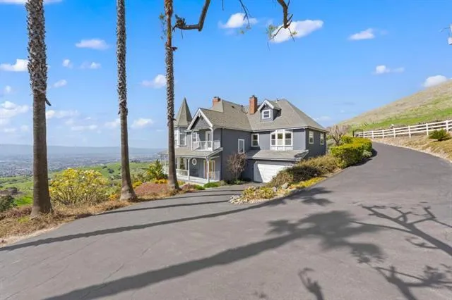 a front view of a house with a garden and street view