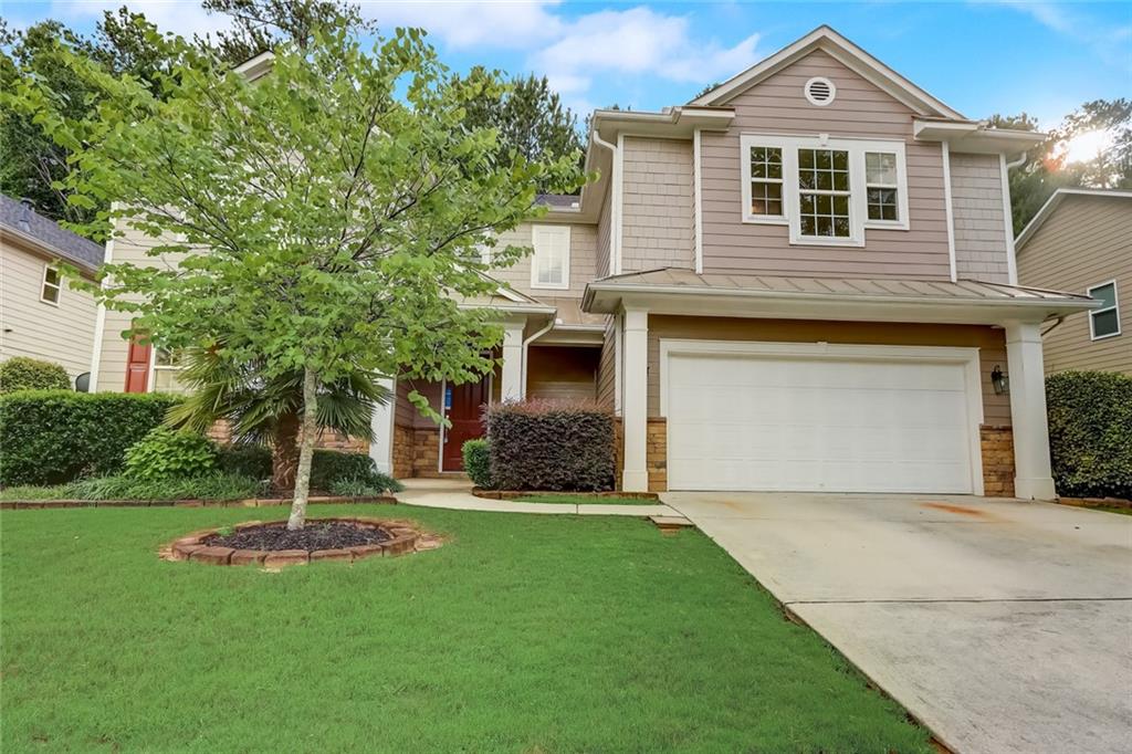 1955 Cutleaf Creek Road Southeast Grayson, GA 30017 - Photo 1 of 1 a front view of a house with a yard and garage