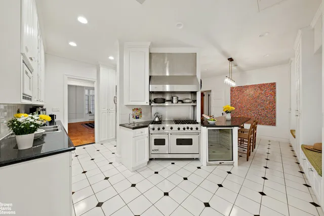 an open kitchen with dining table and chairs