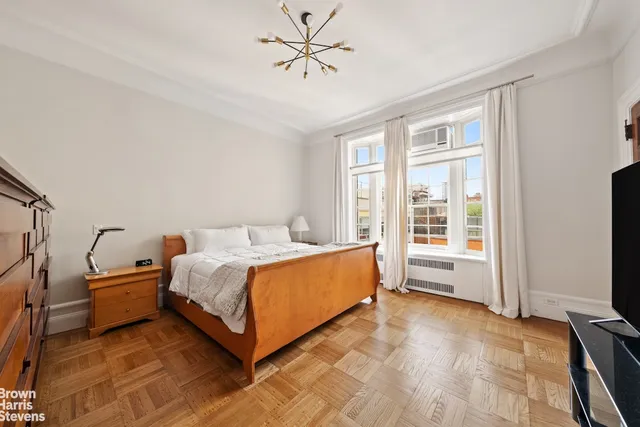 a living room with furniture fireplace and large windows