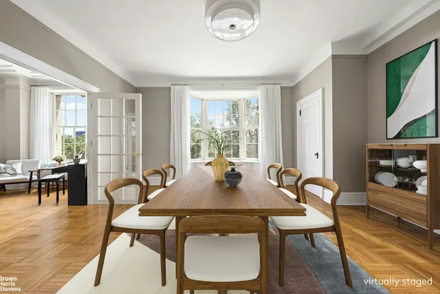 a view of a dining room with furniture and chandelier