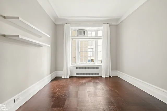 a living room with furniture fireplace and large windows