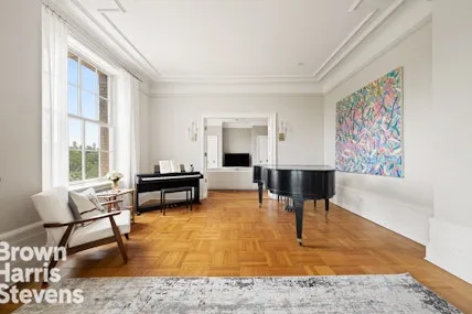 a large white bathroom with a granite countertop sink a toilet and shower