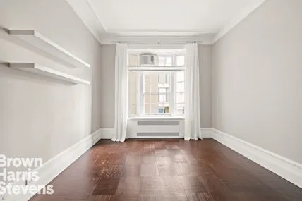 a living room with furniture fireplace and a large window