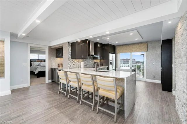 a kitchen with stainless steel appliances kitchen island granite countertop a sink and cabinets