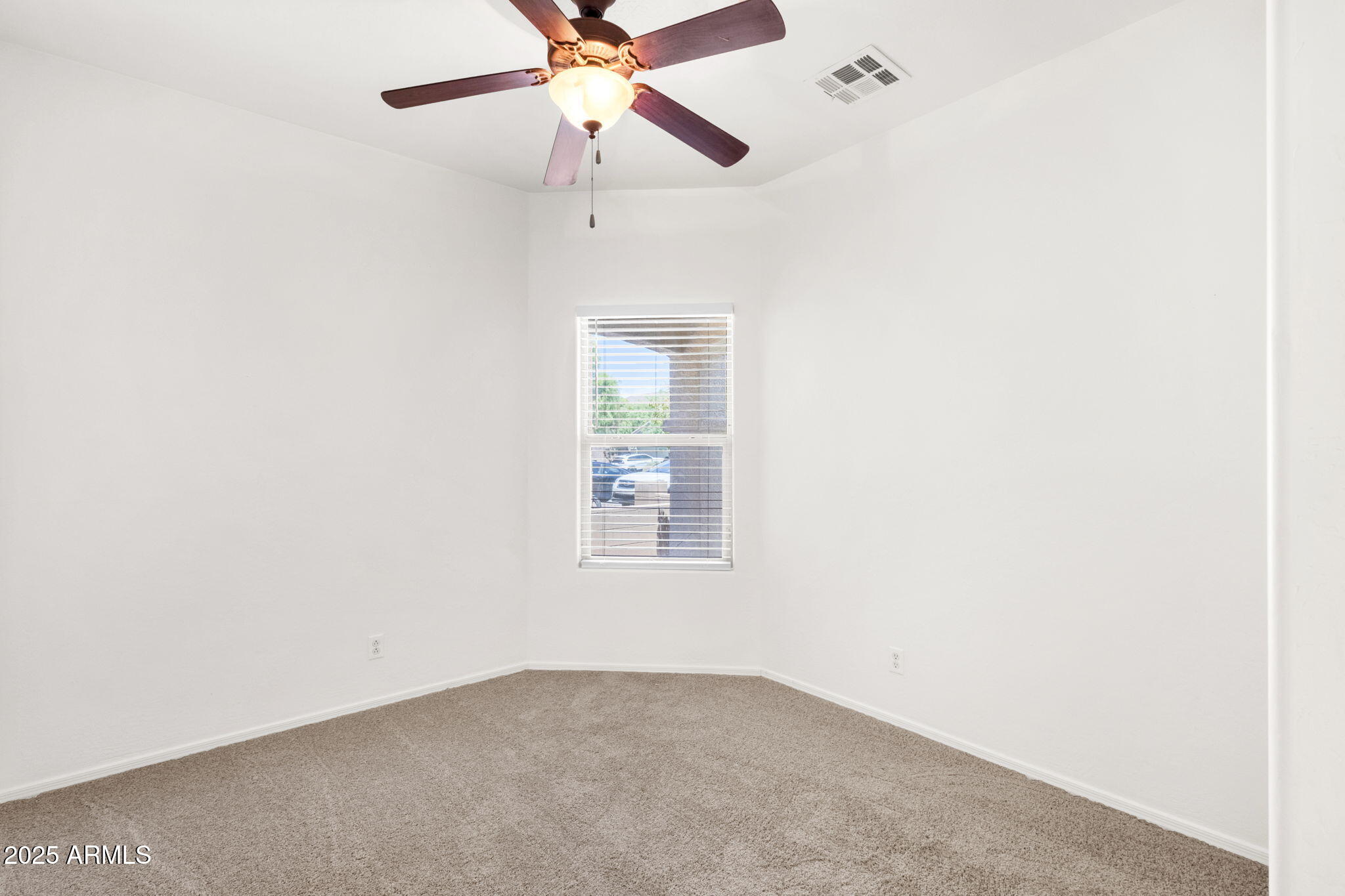 13414 North 87th Lane Peoria, AZ 85381 - Photo 15 of 45 an empty room with a window and a fan