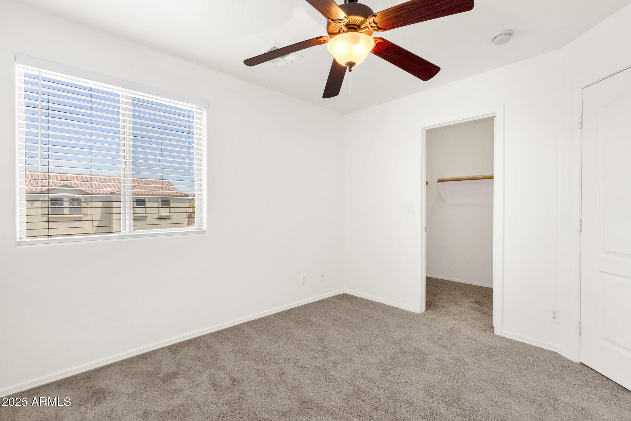13414 North 87th Lane Peoria, AZ 85381 - Photo 23 of 45 an empty room with a window and a fan