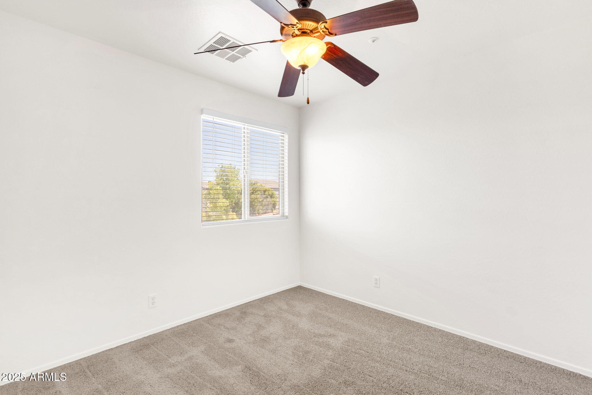 13414 North 87th Lane Peoria, AZ 85381 - Photo 27 of 45 an empty room with a window and a fan