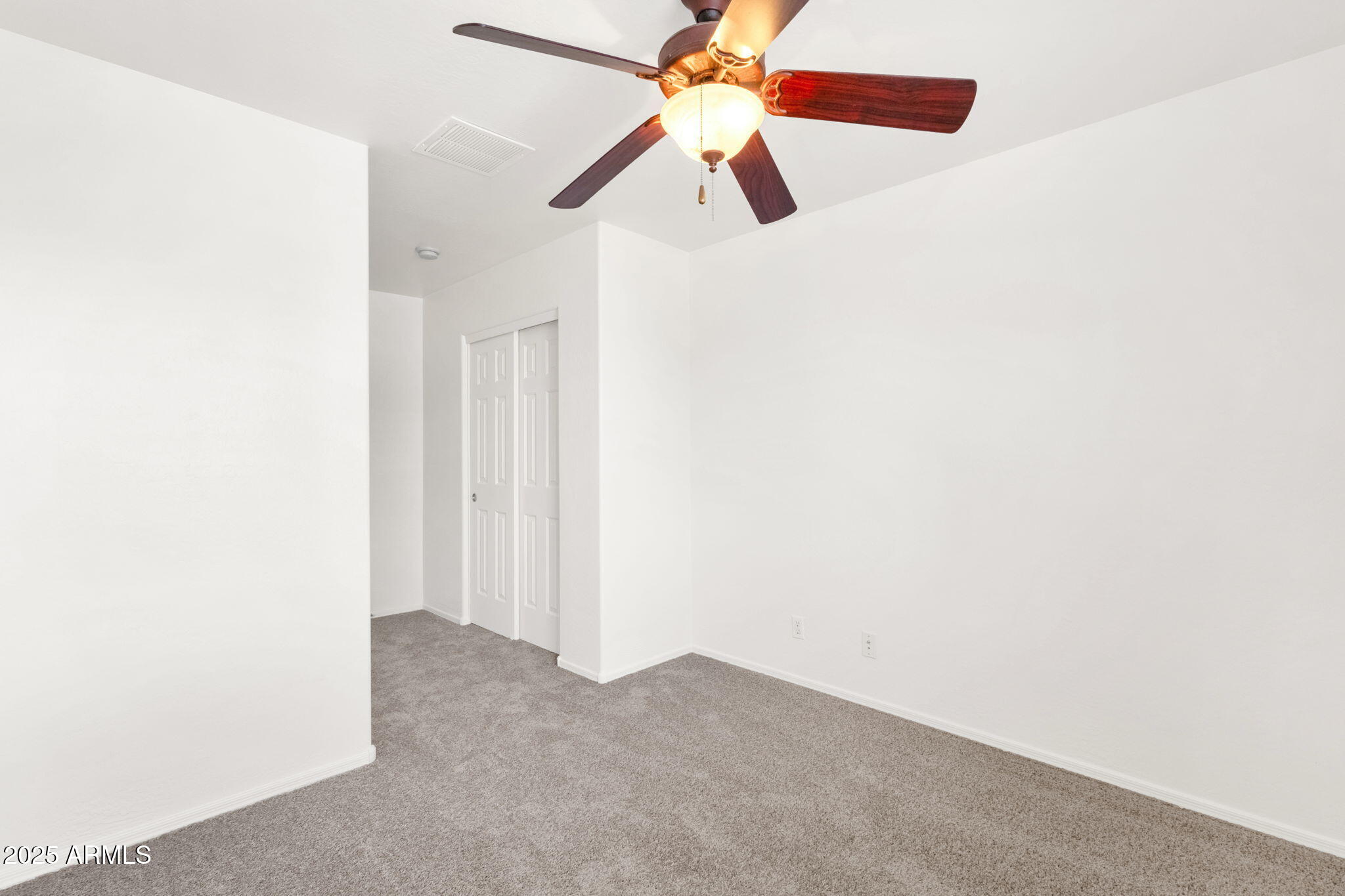 13414 North 87th Lane Peoria, AZ 85381 - Photo 28 of 45 a view of a room with a ceiling fan and a fan