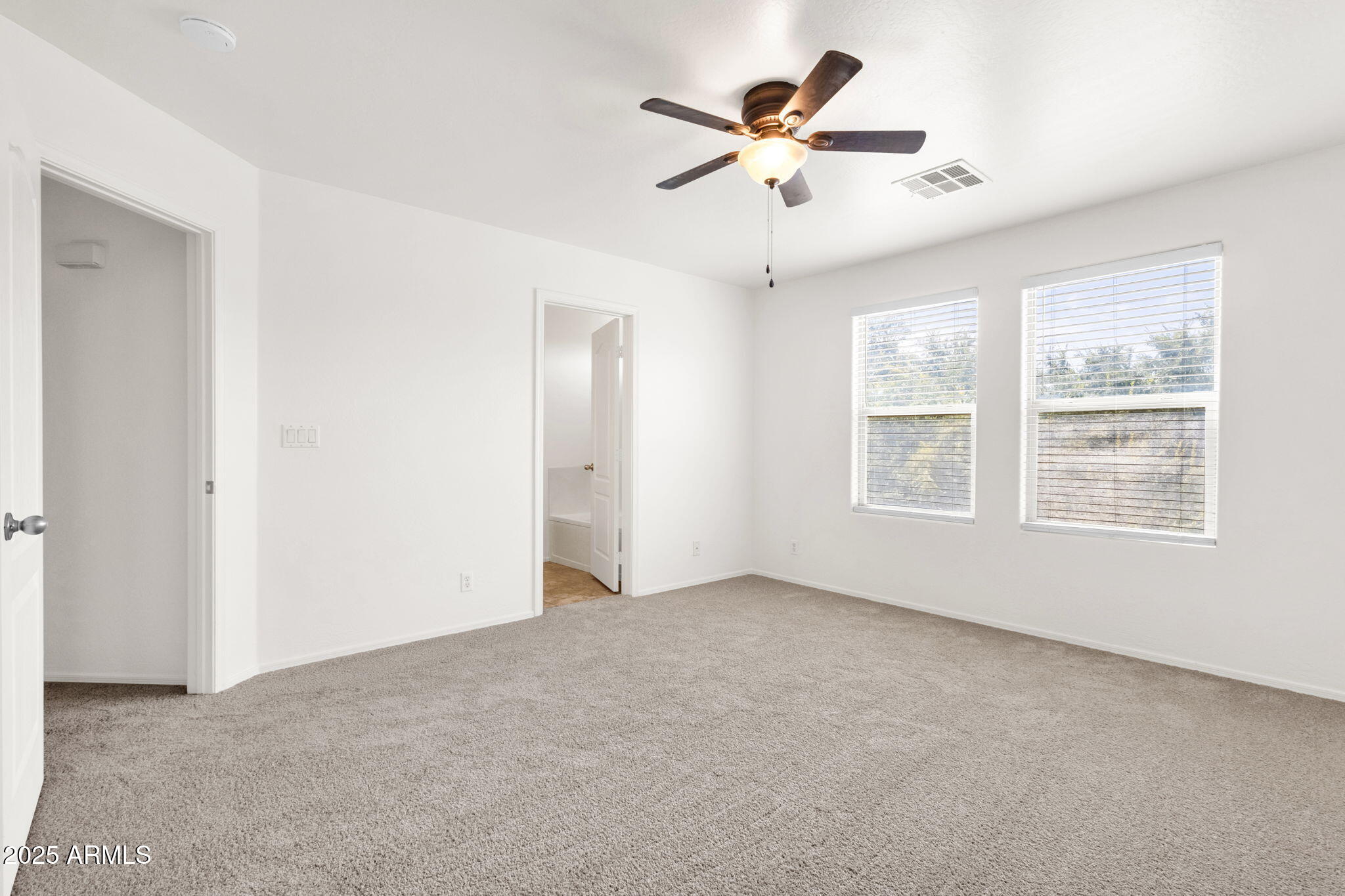 13414 North 87th Lane Peoria, AZ 85381 - Photo 30 of 45 an empty room with windows and fan