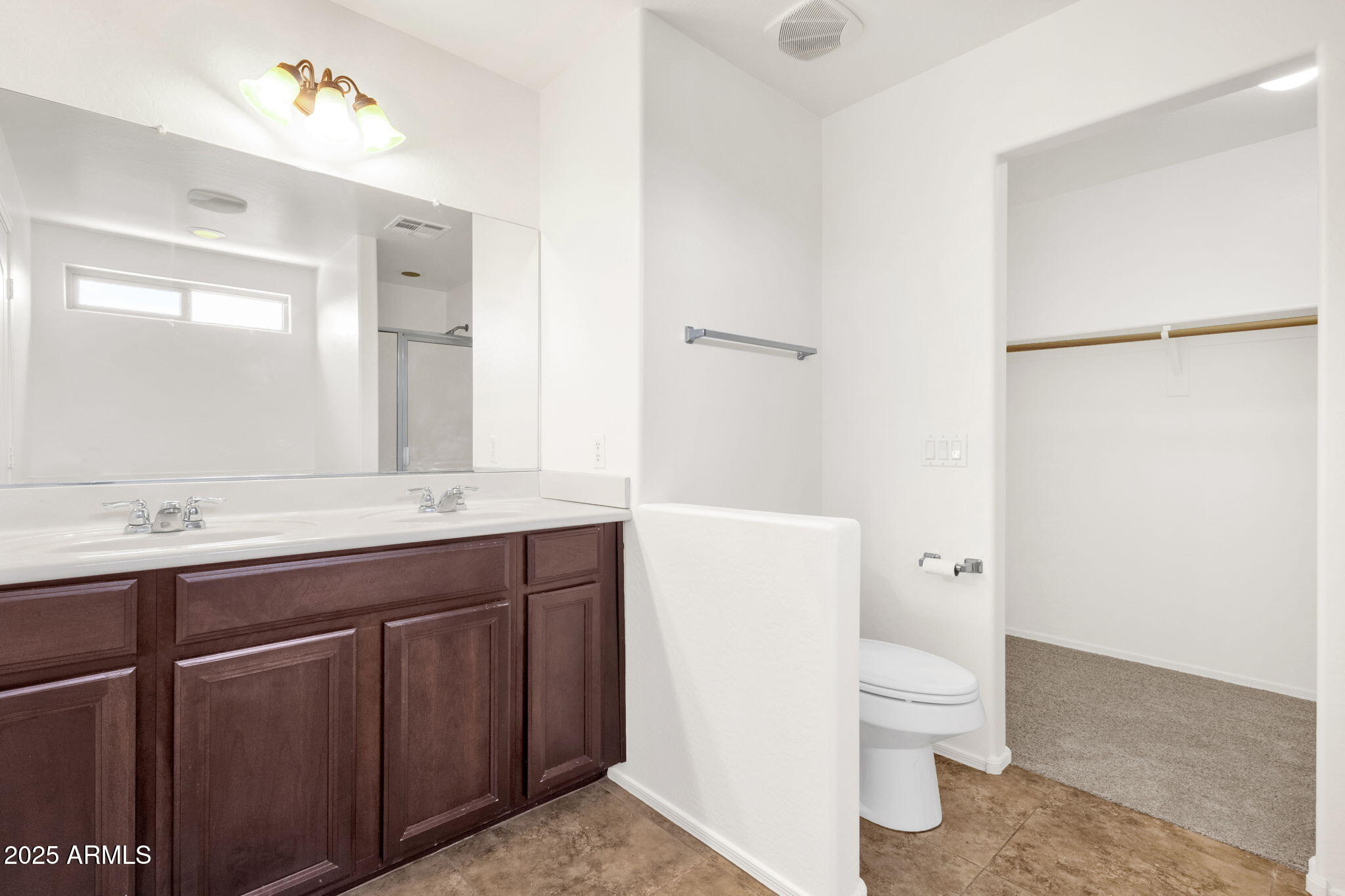 13414 North 87th Lane Peoria, AZ 85381 - Photo 32 of 45 a bathroom with a sink a toilet and a mirror
