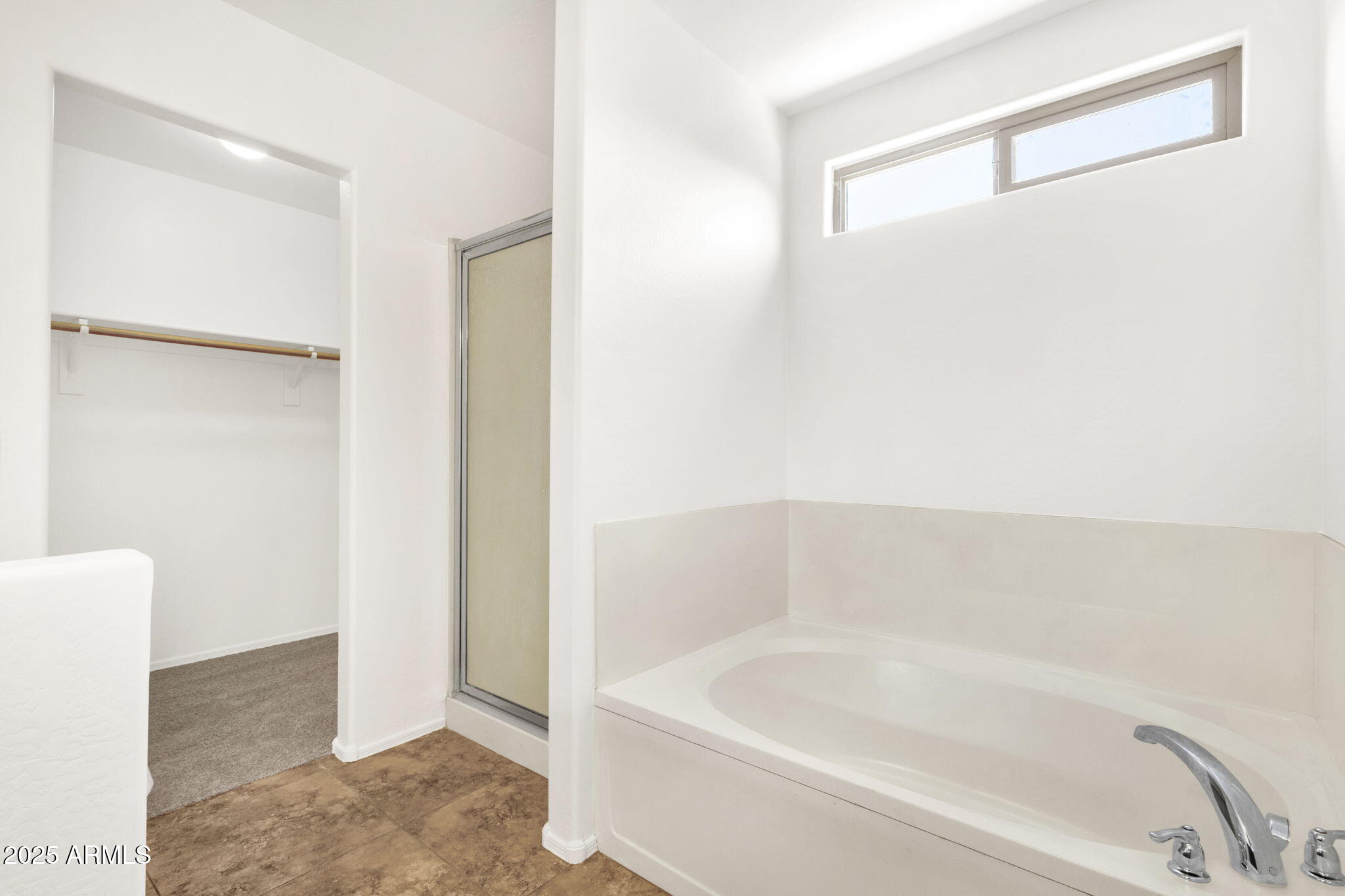 13414 North 87th Lane Peoria, AZ 85381 - Photo 33 of 45 a bathroom with a bathtub and a shower