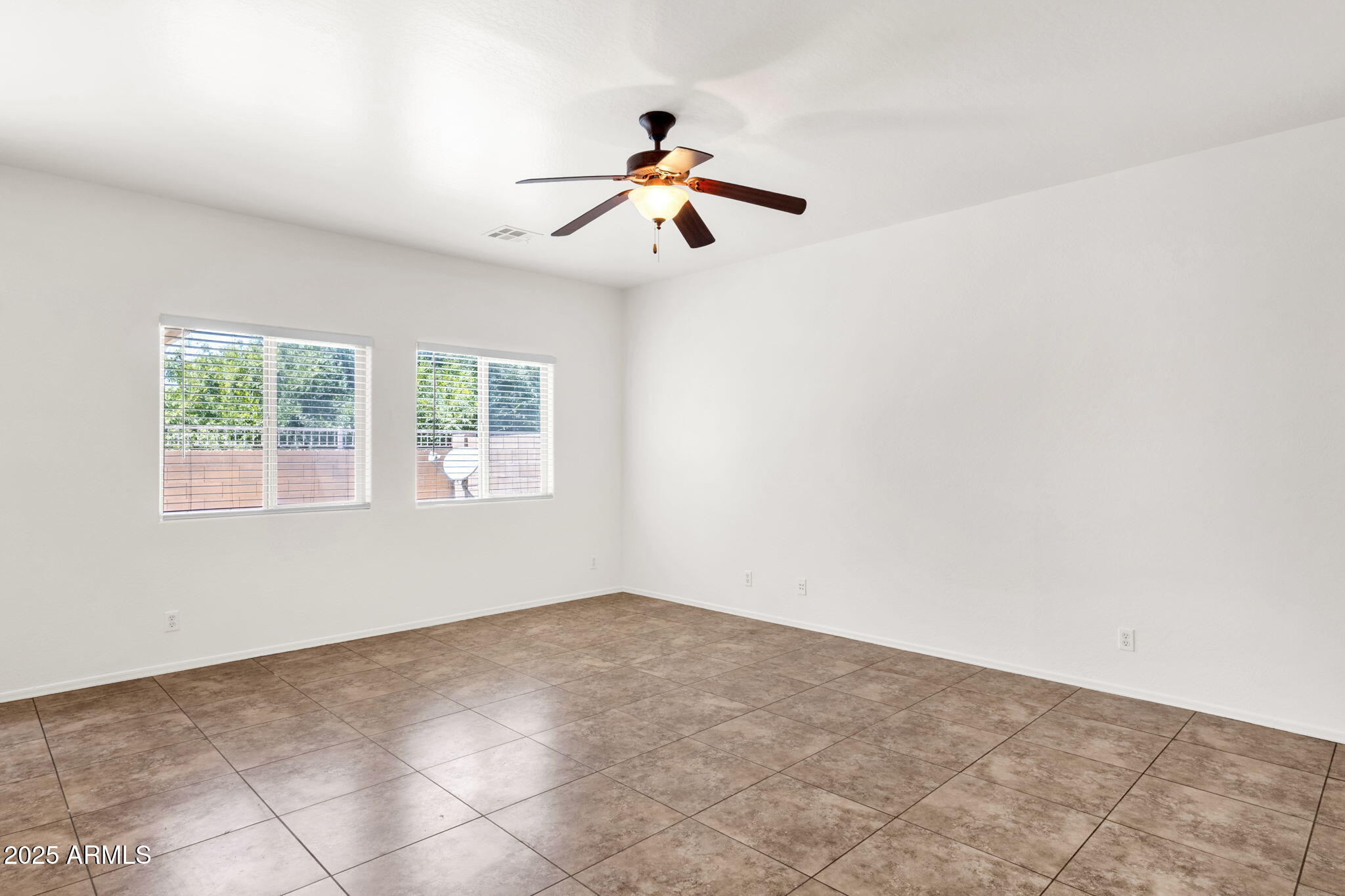 13414 North 87th Lane Peoria, AZ 85381 - Photo 7 of 45 a view of a ceiling fan and window in a room