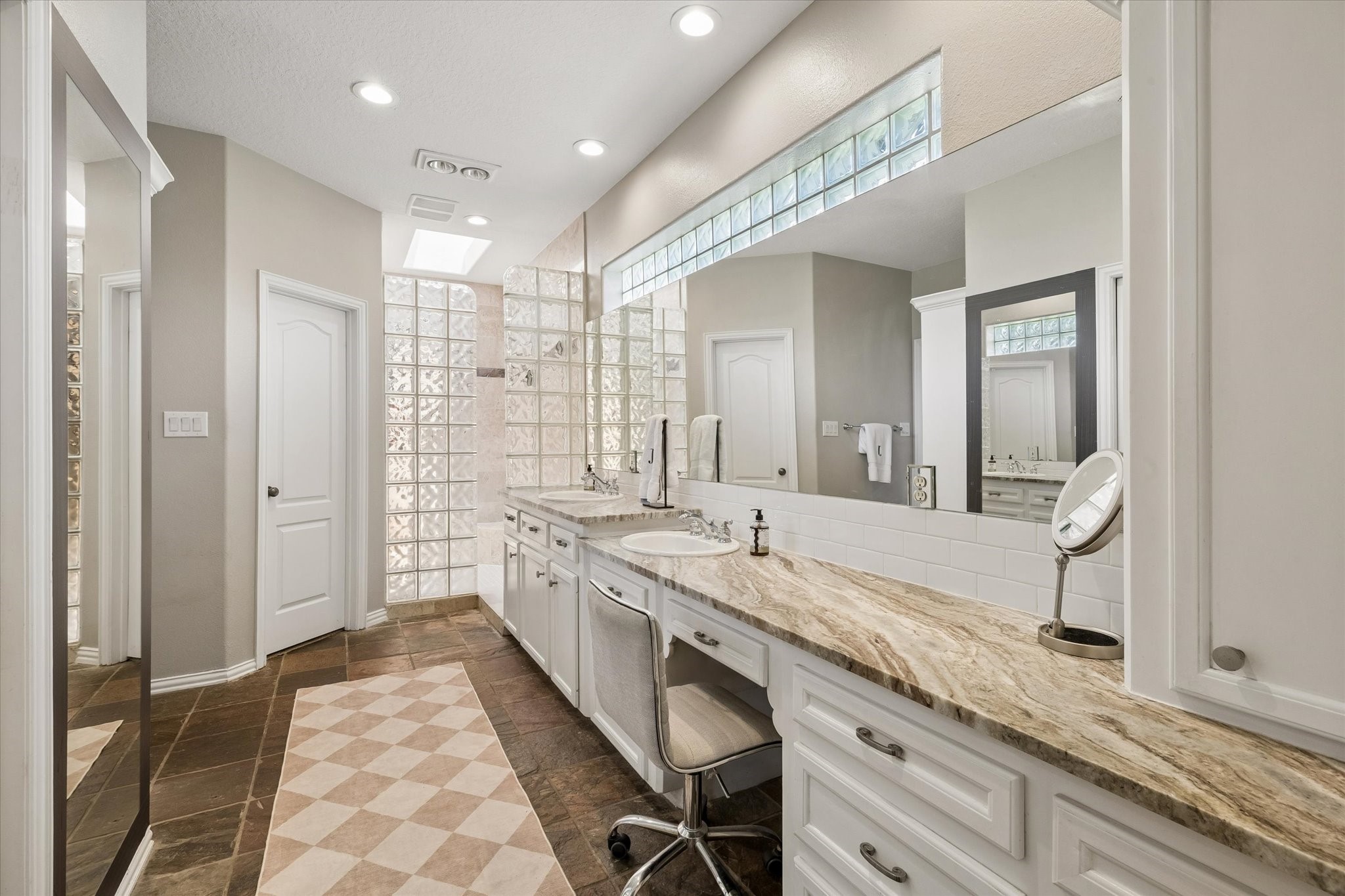 6819 Still Meadow Street Spring, TX 77389 - Photo 30 of 50 The elegant bathroom features a spacious dual-sink vanity with granite countertops, glass block accents and a large walk-in shower