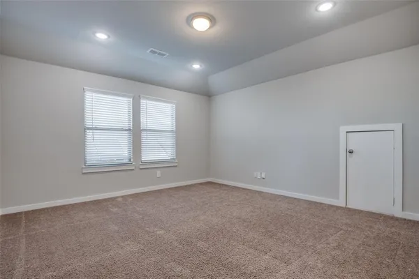 an empty room with windows and closet
